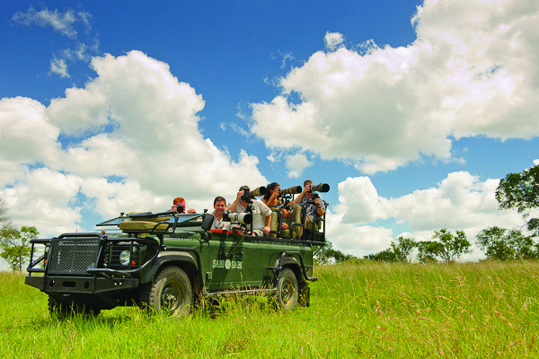 Photographers on safari vehicles, chasing perfect shots. Photographers on safari vehicles, chasing perfect shots.