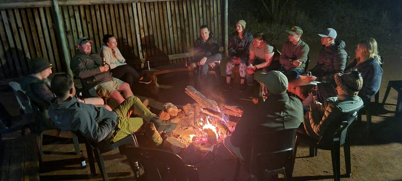 Guides chat around a campfire. Guides chat around a campfire.