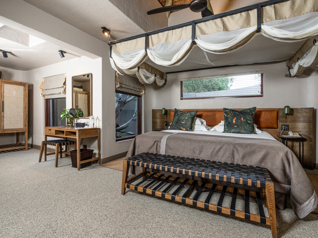 Unwind on a spacious king-sized bed at Sabi Sabi Bush Lodge.