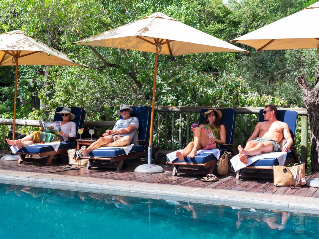Indulge in sun-soaked poolside bliss at Sabi Sabi, with a refreshing beverage in hand. Indulge in sun-soaked poolside bliss at Sabi Sabi, with a refreshing beverage in hand.