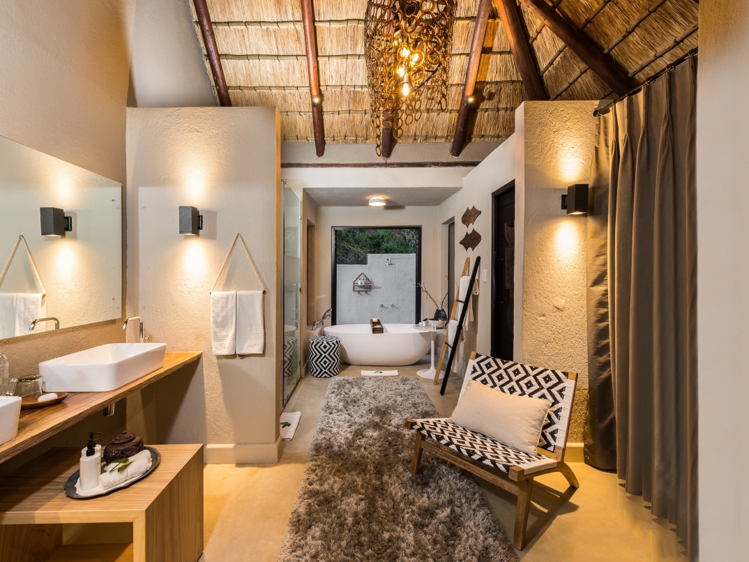 Luxury Suite with a spacious wooden sundeck and signature spa bath at Little Bush Camp. Luxury Suite with a spacious wooden sundeck and signature spa bath at Little Bush Camp.