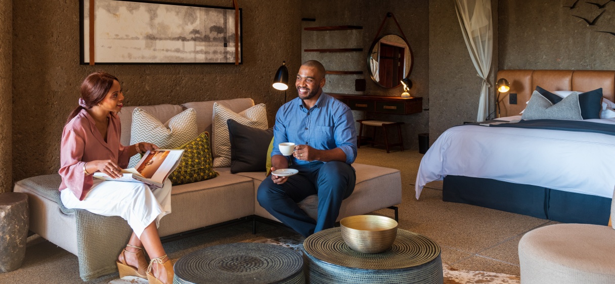 Guest in Earth Lodge suite drinking tea