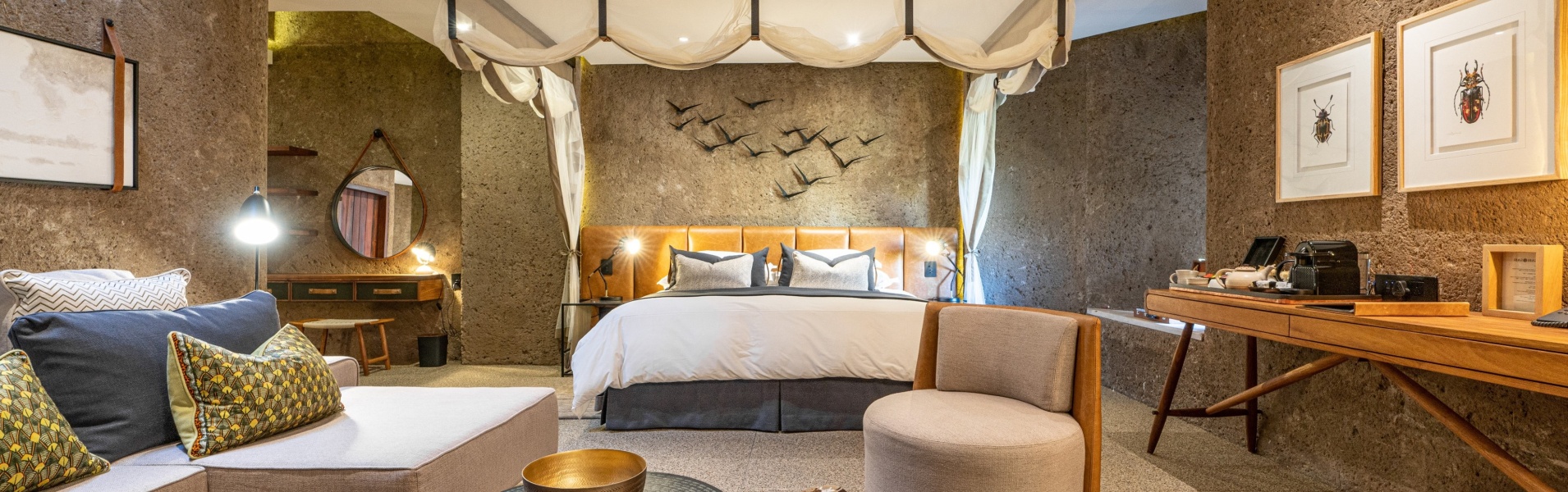 Earth Lodge Luxury Suite expansive indoor lounge and bedroom.