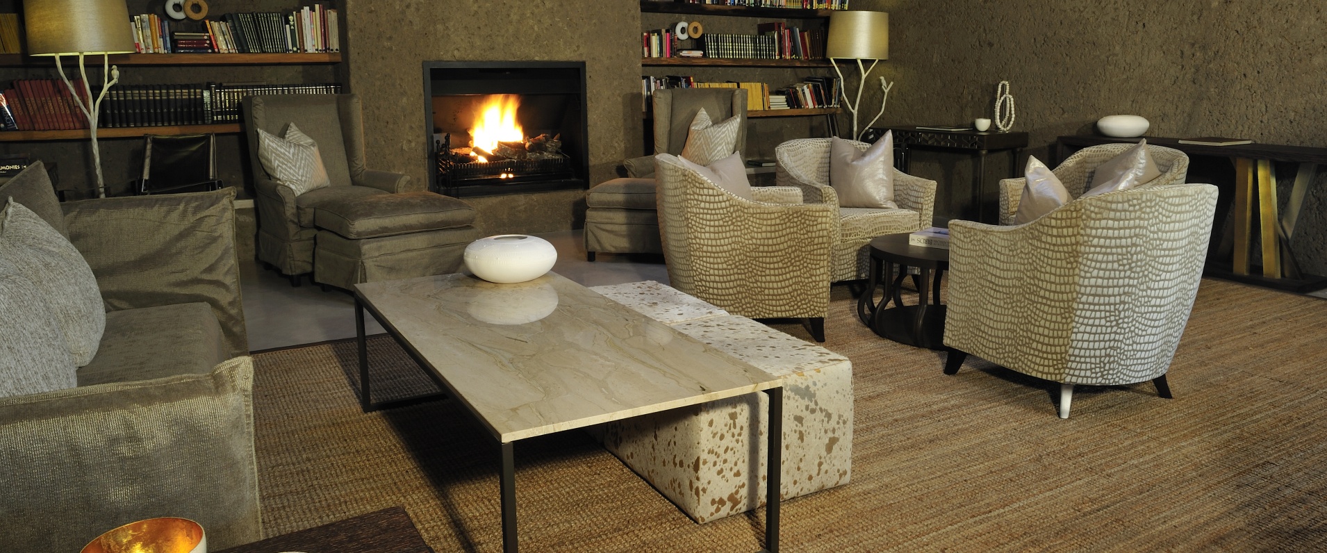 The Sabi Sabi Earth Lodge luxurious lounge and fireplace area creates a welcoming feeling.