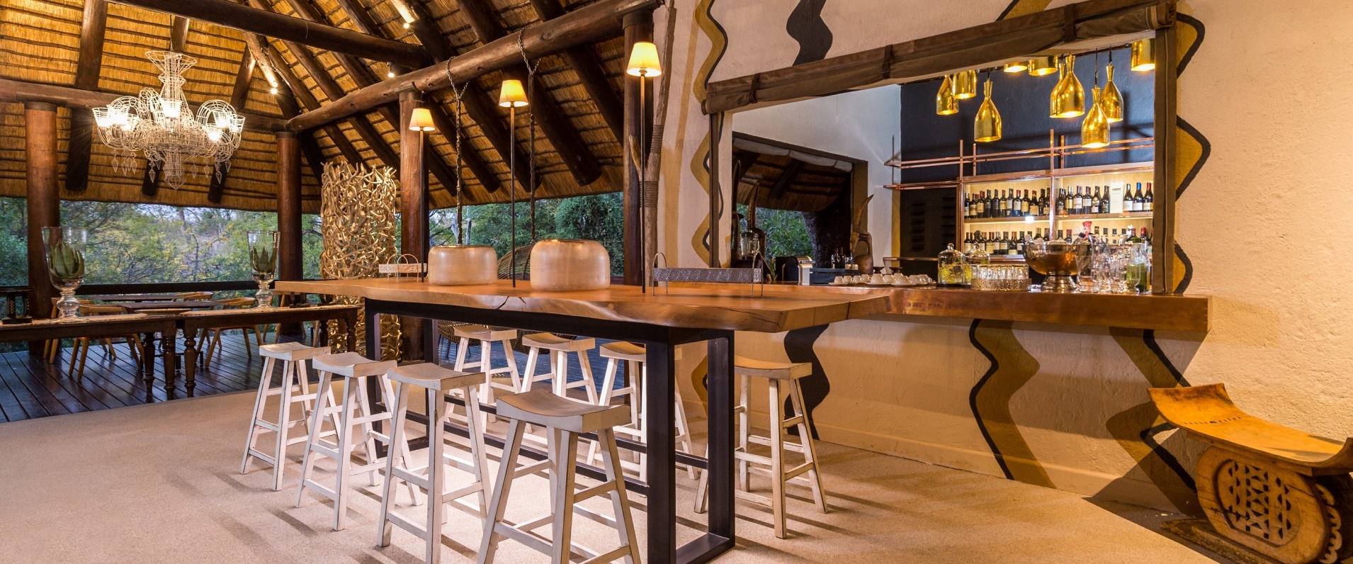 Little Bush Camp bar nestled under the high-thatched eaves with bush views.