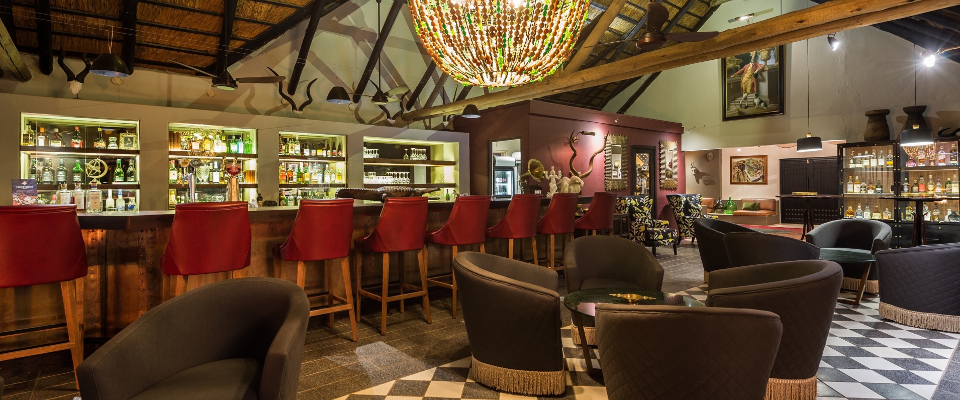 Step into opulence at the exquisitely furnished lounge, atrium, and bar area at Bush Lodge, Sabi Sabi.
