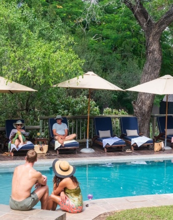 Guests at Sabi Sabi relax by the swimming pool.
