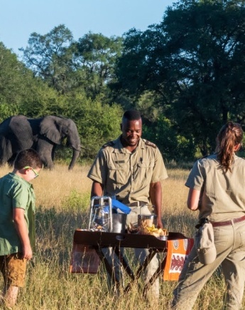Friends gather around for a coffee during an early morning game drive in the Sabi Sands.