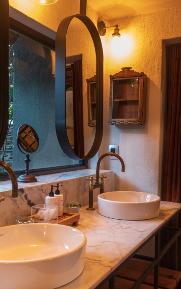 Indulge in the lavishness of the meticulously designed his and hers bathrooms at Selati Camp.