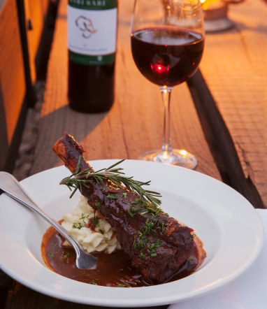 Springbok shank and red wine served at Sabi Sabi Bush Lodge. Springbok shank and red wine served at Sabi Sabi Bush Lodge.