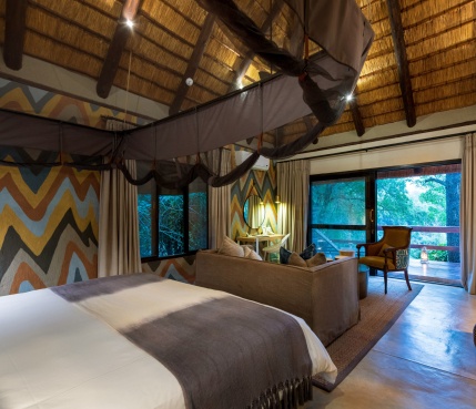 Expansive bedroom leading to a private deck overlooking the Sabi Sabi bush at Little Bush Camp. Expansive bedroom leading to a private deck overlooking the Sabi Sabi bush at Little Bush Camp.