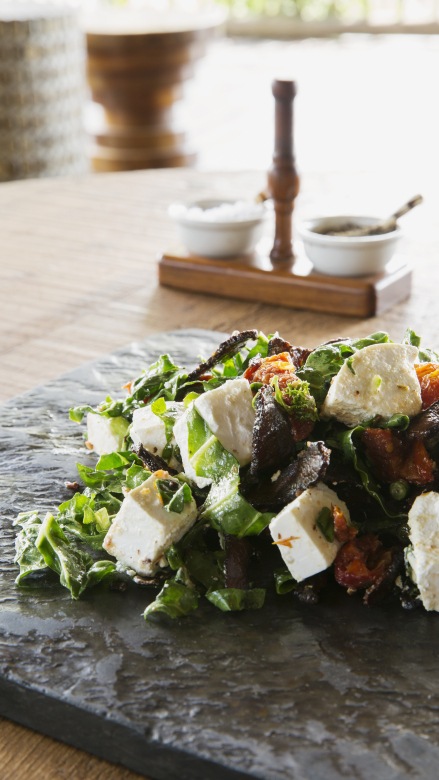 Sabi Sabi's experienced chef preparing a biltong spinach and sundried tomato with feta salad.