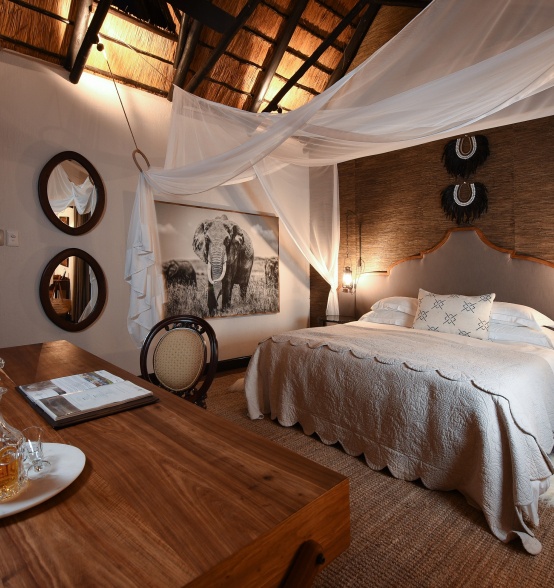 Experience the opulent embrace of a King-size bed, luxuriously adorned with soft mosquito netting, at Selati Camp.