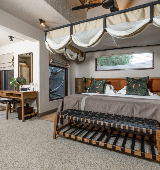Unwind on a spacious king-sized bed at Sabi Sabi Bush Lodge.