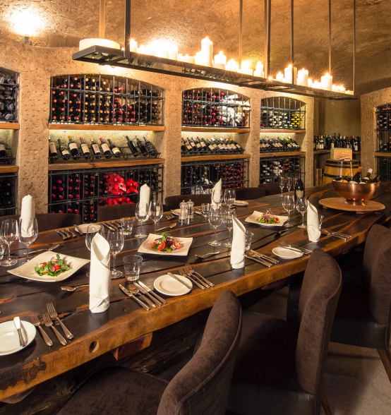 Elevate dining at Earth Lodge's wine cellar, where exquisite meals and fine vintages await.