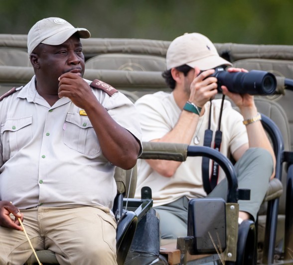 A Sabi Sabi guide looks in the direction that a guest is capturing