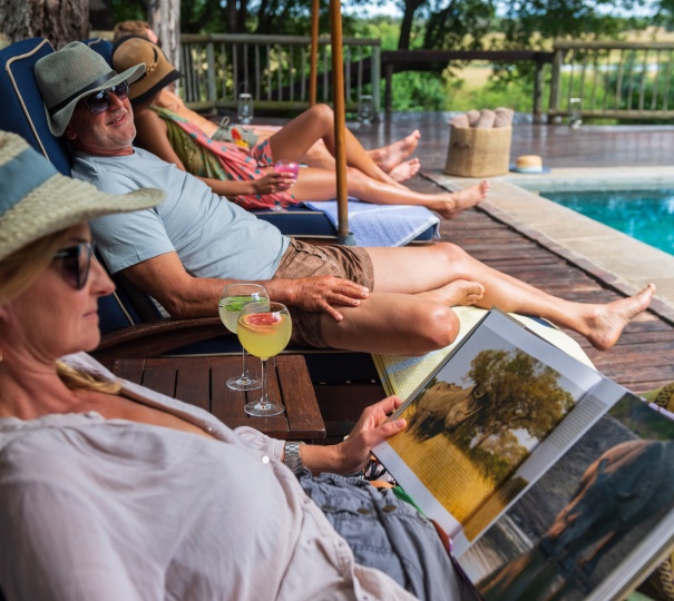 Guests enjoying the sunlight and refreshments at Sabi Sabi's private pool. Guests enjoying the sunlight and refreshments at Sabi Sabi's private pool.