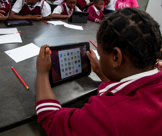 School student interacting with a electronic tablet. School student interacting with a electronic tablet.
