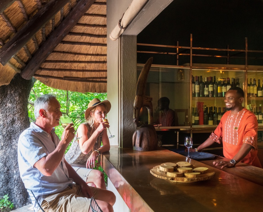 Sabi Sabi guests interacting with Little Bush Camp staff while enjoying a refreshment at the bar. Sabi Sabi guests interacting with Little Bush Camp staff while enjoying a refreshment at the bar.