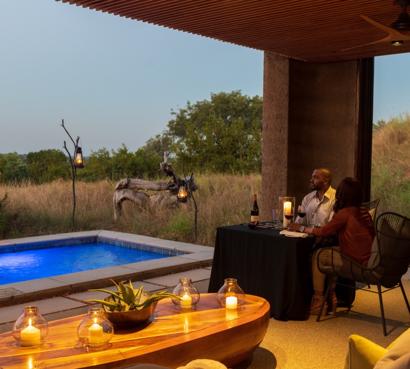 Sabi Sabi guests on a romantic getaway enjoying a meal while overlooking the safari bush. Sabi Sabi guests on a romantic getaway enjoying a meal while overlooking the safari bush.