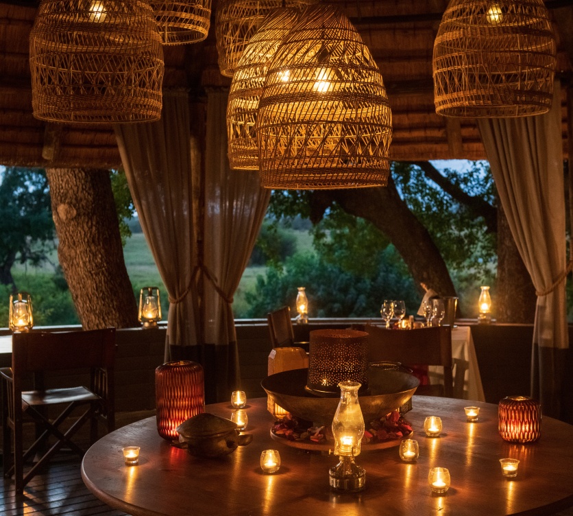 Romantic dinner under soft lantern glow at Selati Camp. Romantic dinner under soft lantern glow at Selati Camp.