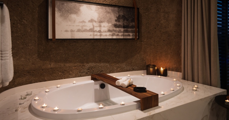 Earth Lodge Luxury Suite bathroom candlelit for romance.