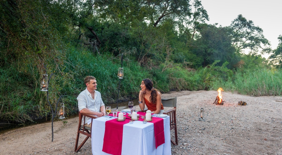 Sabi Sabi couple having a romantic dinner along the Msuthlu riverbed at Little Bush Camp. Sabi Sabi couple having a romantic dinner along the Msuthlu riverbed at Little Bush Camp.
