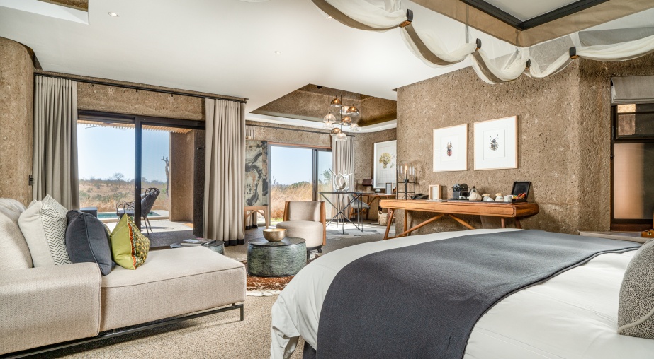 Experience the seamless integration of a spacious bedroom with the natural surroundings in Earth Lodge's Luxury Suite.