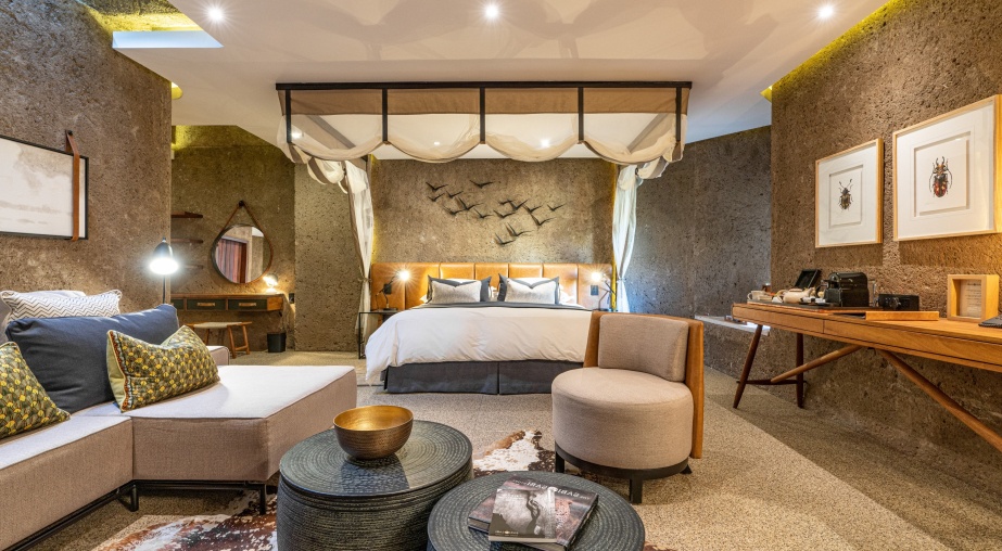 Earth Lodge Luxury Suite expansive indoor lounge and bedroom.