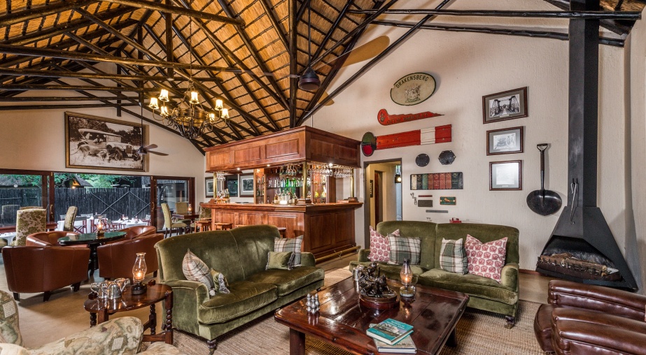 Indulge in the opulence of Selati Camp's lounge and bar, where luxury seamlessly blends with relaxation.