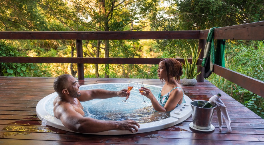 Sabi Sabi couple enjoying the private jacuzzi and refreshments at the Little Bush Camp Luxury Suite. Sabi Sabi couple enjoying the private jacuzzi and refreshments at the Little Bush Camp Luxury Suite.