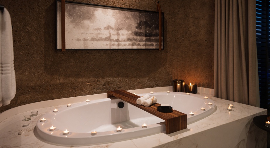 Earth Lodge Luxury Suite bathroom candlelit for romance.