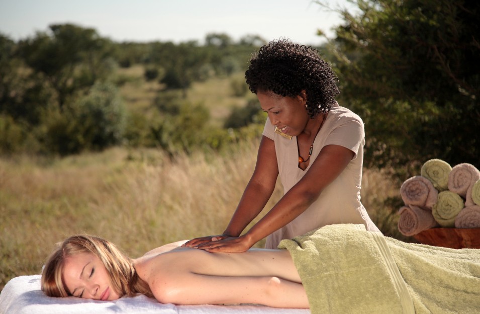 Sabi Sabi guest luxuriating in an outdoor massage at Amani Spa, nature's soothing embrace. Sabi Sabi guest luxuriating in an outdoor massage at Amani Spa, nature's soothing embrace.